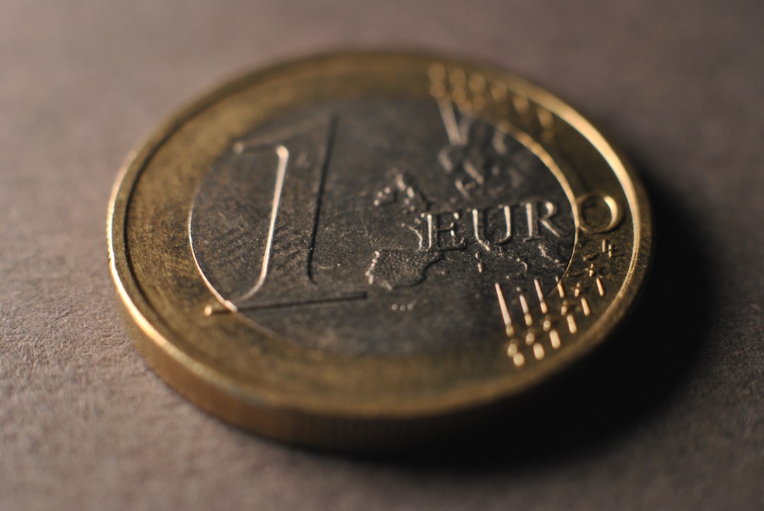 Gold bar set against a backdrop of financial charts, illustrating market analysis and price movements.