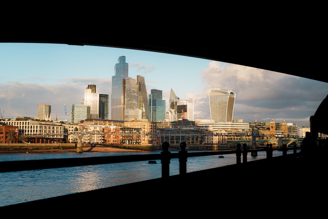 Gold bars symbolizing financial stability and investment against a backdrop of market charts.