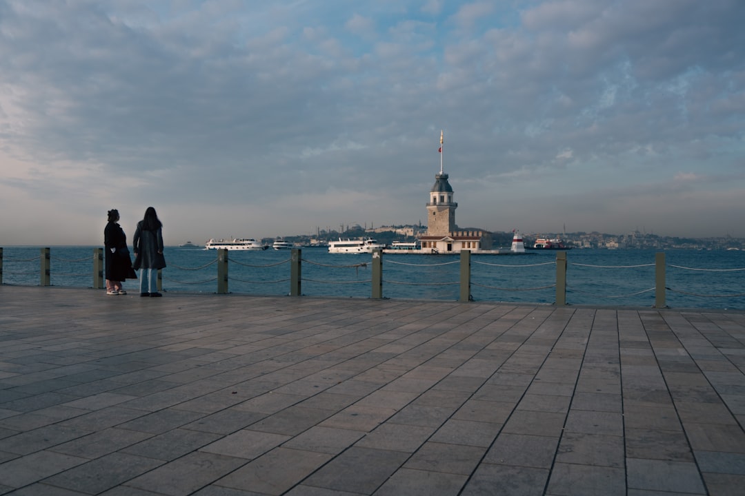 Monero (XMR) digital currency logo overlaying a candlestick chart, representing market analysis and price volatility.