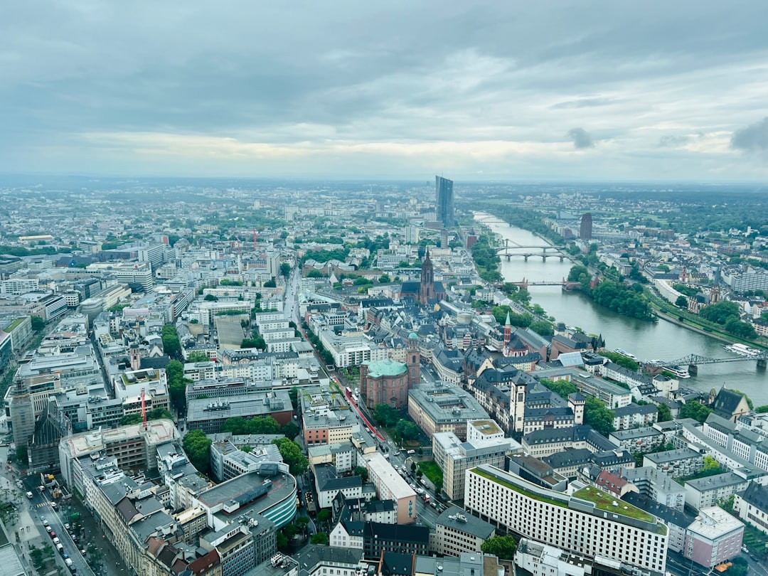 Factory with stockpiled goods and financial charts showing rising costs, symbolizing the cost of resilience in the global economy.