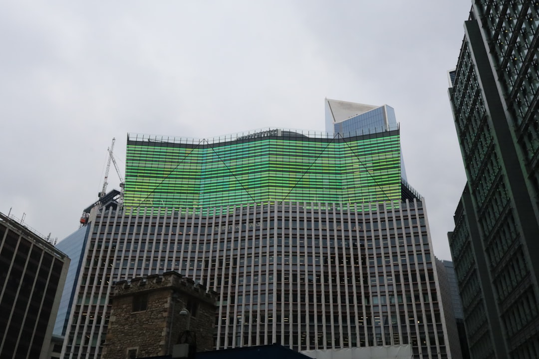 A financial chart illustrating the TSX index performance with candles and technical indicators, set against a backdrop of global market data screens.