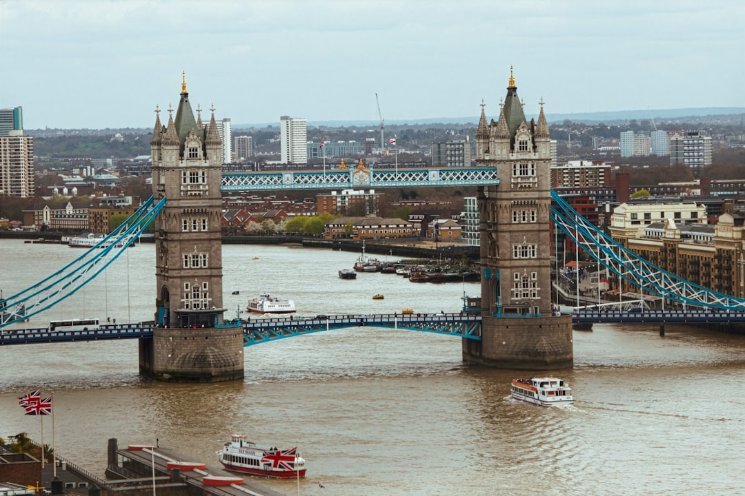 USD/CAD currency pair chart showing a pivot point at 1.37000, with support and resistance levels. A Canadian loonie coin and a US dollar bill are depicted in the background.