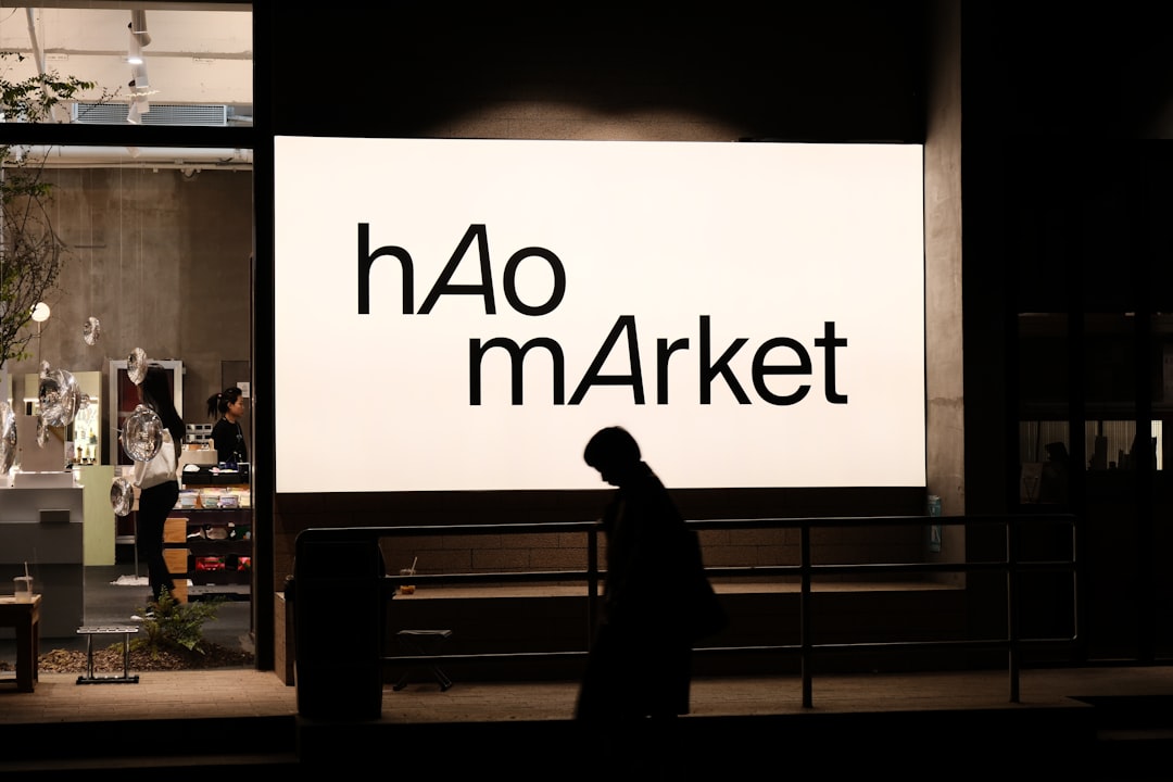 HBAR price analysis: Person at Hao Market sign, watching $0.083 support for Hedera.