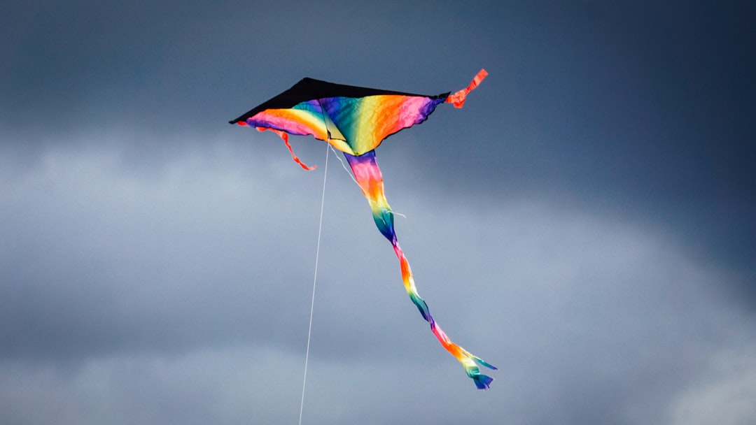 Kite KITE price crypto chart with red, yellow, blue umbrella illustration