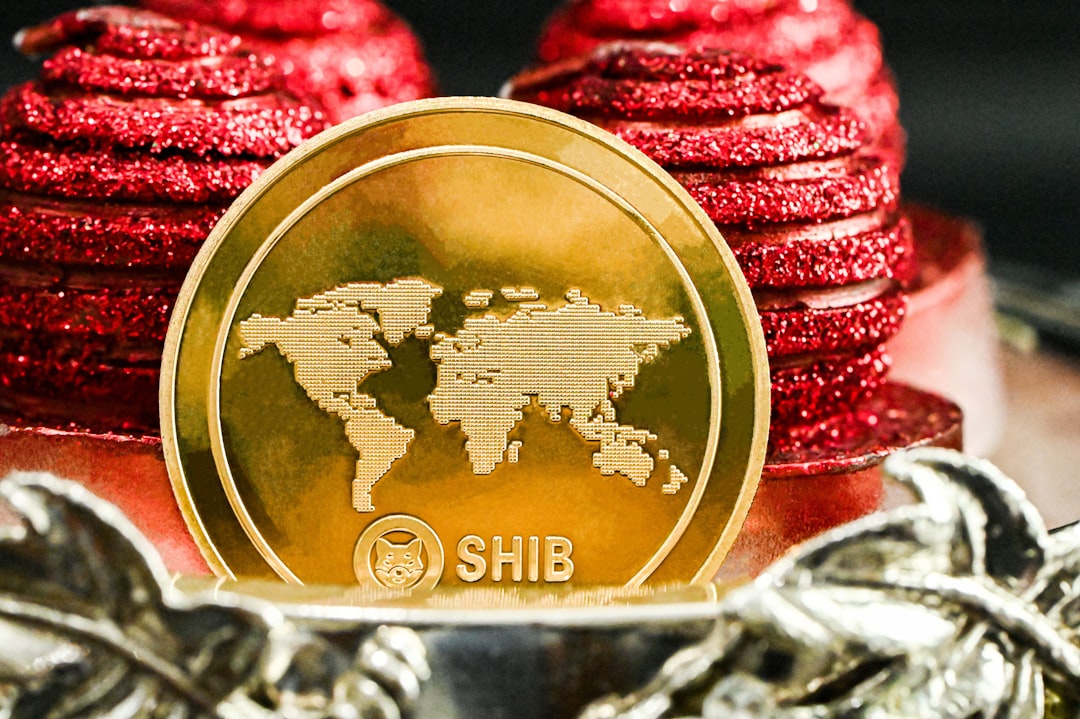 A gold SHIB coin rests on red cookies, symbolizing Shiba Inu's $0.00000606 price navigation amidst market volatility.