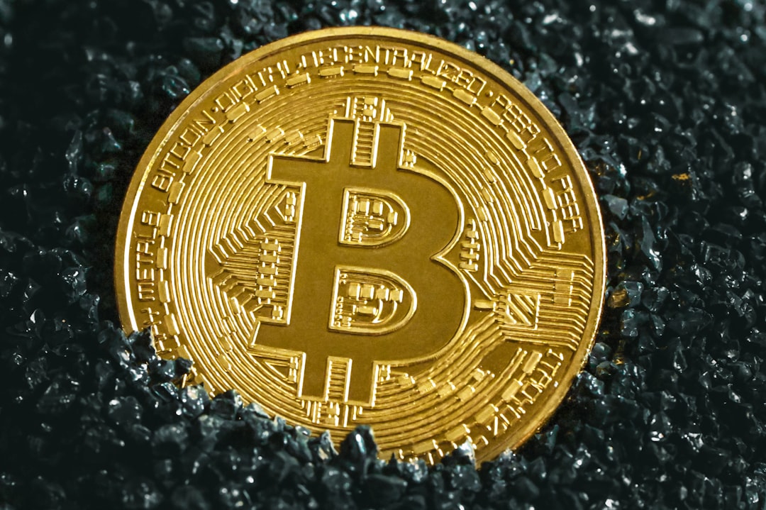 Bitcoin atop black surface, symbolizing Optimism (OP) price action towards $0.196 resistance.
