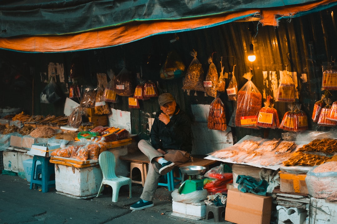 people standing in front of food stall during nighttime
