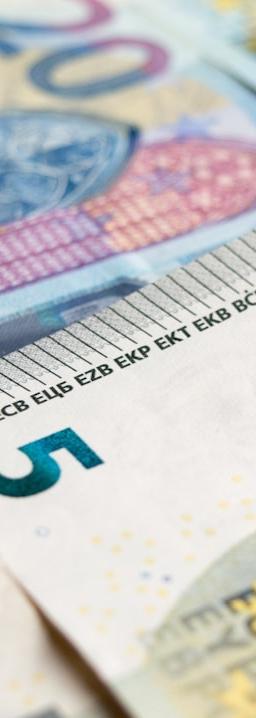 US Dollar currency notes with a subtle pivot arrow and global financial charts