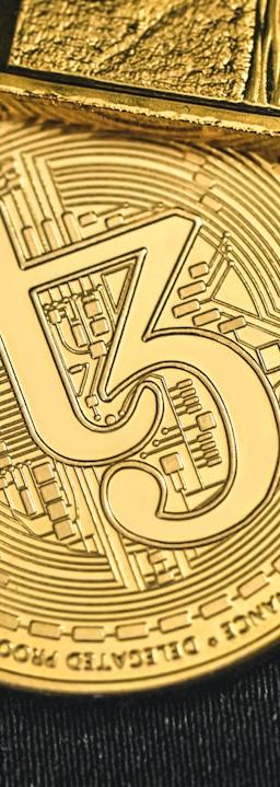 a gold coin with a cell phone on top of it