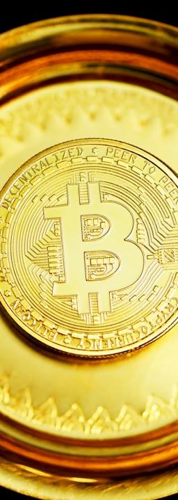 gold round coin on black surface