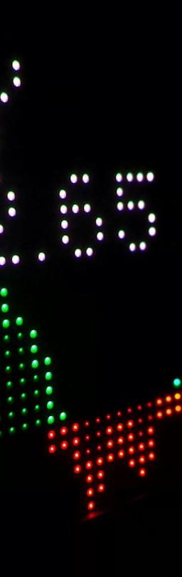 a close up of a clock with different colored numbers