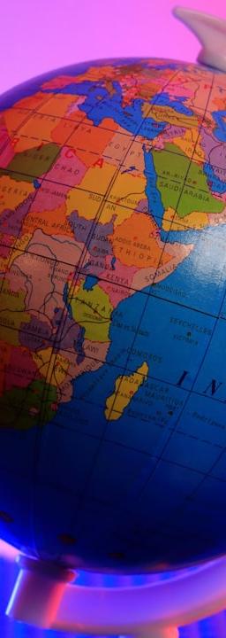 a blue and orange globe with a pink background