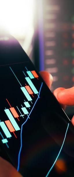 Hands holding smartphone showing stock market data