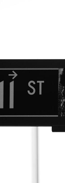 grayscale photo of Wall St. signage