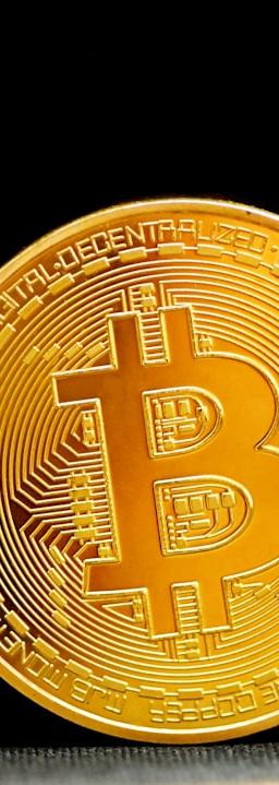 gold round coin on black textile