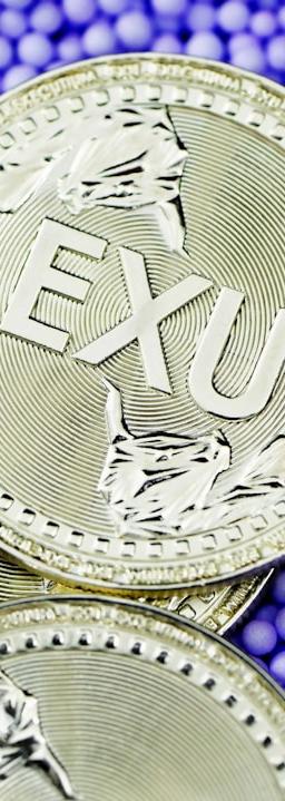 silver round coin on purple and blue beads