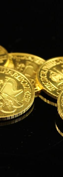 gold round coins on black surface