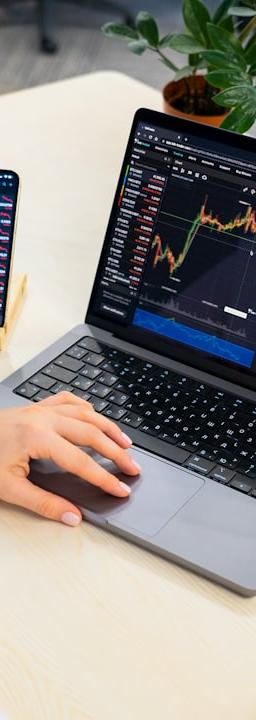 a woman sitting at a table using a laptop computer
