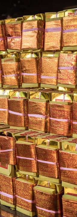a stack of orange wrapped packages sitting on top of a counter