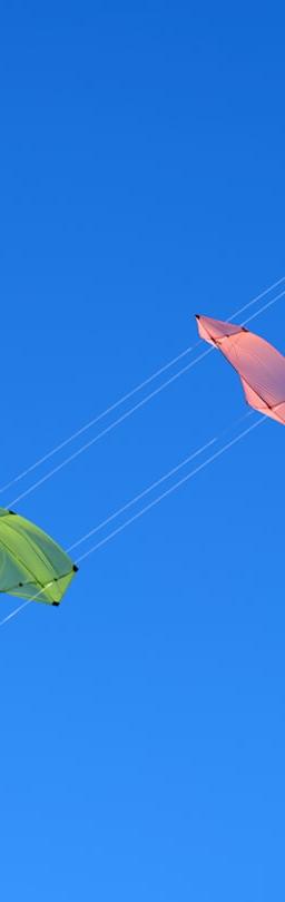 Kite KITE crypto price dipping with colorful kites against blue sky