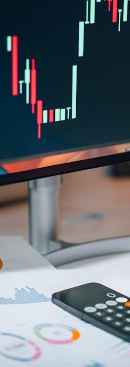 a person pointing at a calculator on a desk