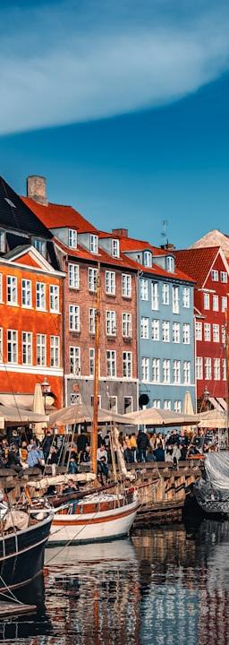 a harbor filled with lots of boats next to tall buildings